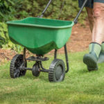 lawn fertilizing equipment being used by a person