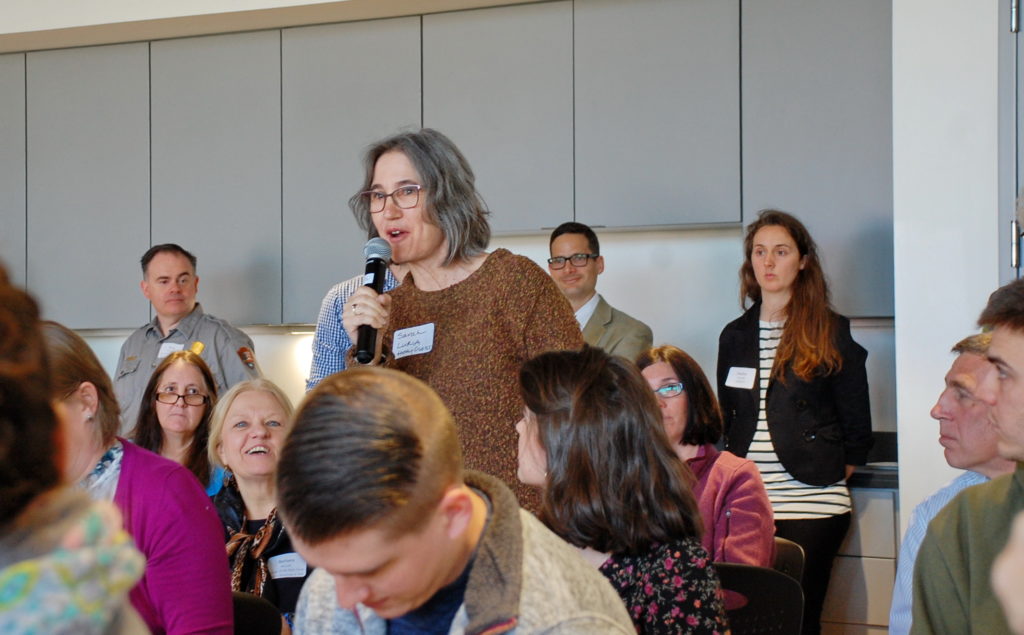 Woman with microphone standing in the audience