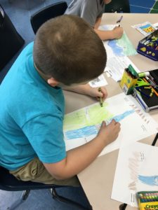 Boy coloring in a classroom
