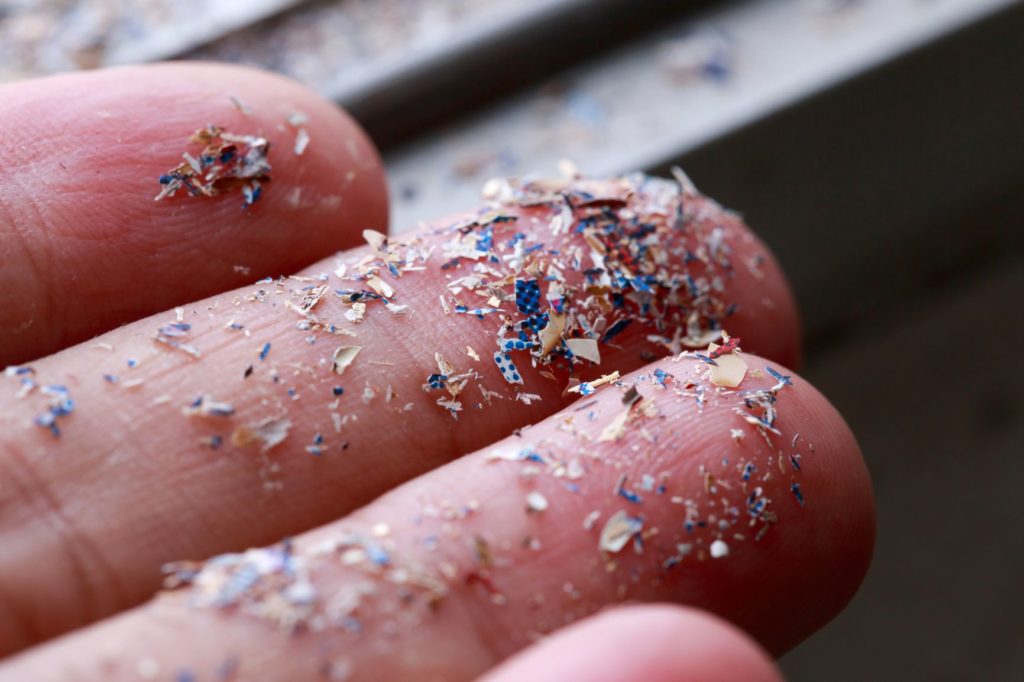 fingers with microplastics on them