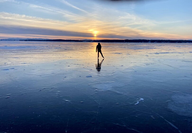 Ice skating on Lake Champlain at sunset.