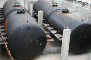 Two underground storage tanks in a concrete enclosure.