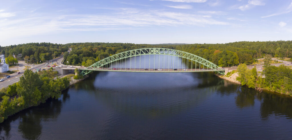 Aerial view of the Merrimack River with a bridge crossing it.