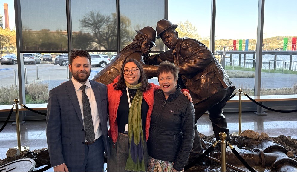 Three NEIWPCC staff members, including Executive Director Susan Sullivan and two young professionals, Ryan Buckley and Daphne Short, pose in front of a statue at the National Water Policy Fly-In.