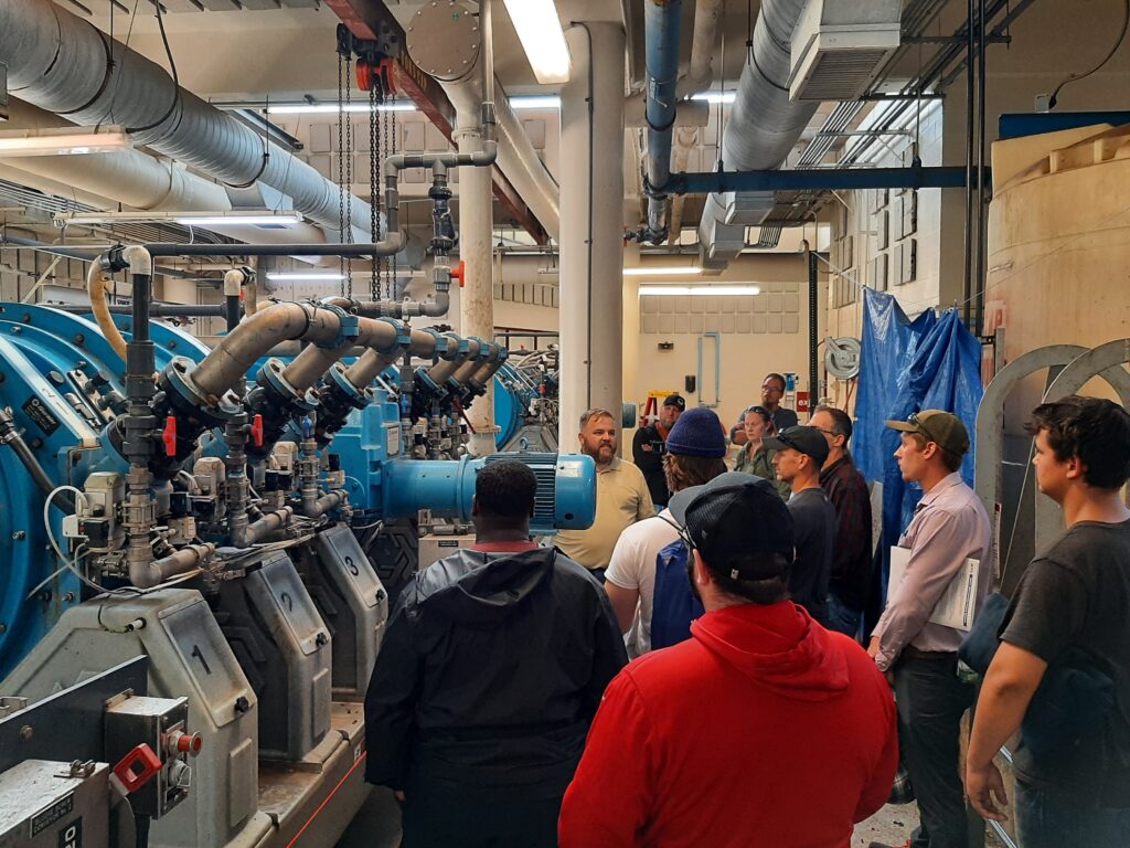 Group of people touring the inside of a wastewater treatment plant in Maine.