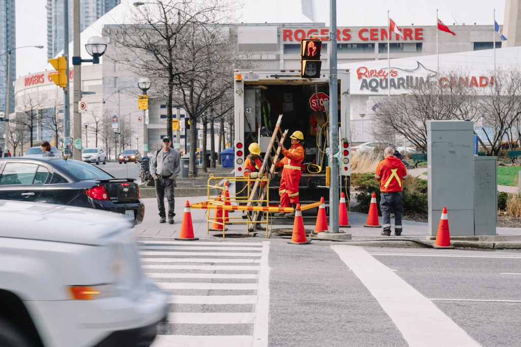 Crew workers in orange outfits at an intersection