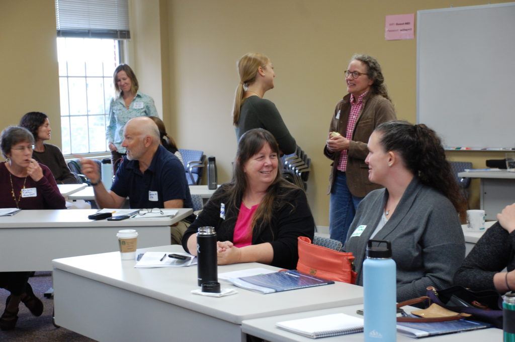 A group of people talk at a water quality standards meeting